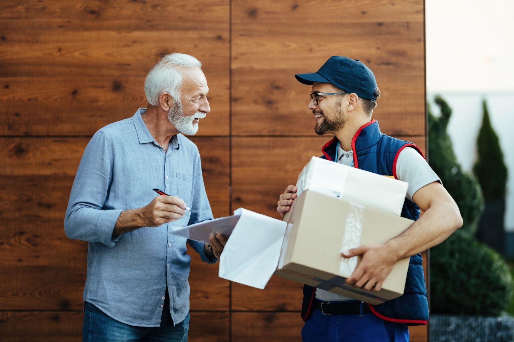 happy-senior-man-communicating-with-courier-while-2026-03-16-03-29-30-utc